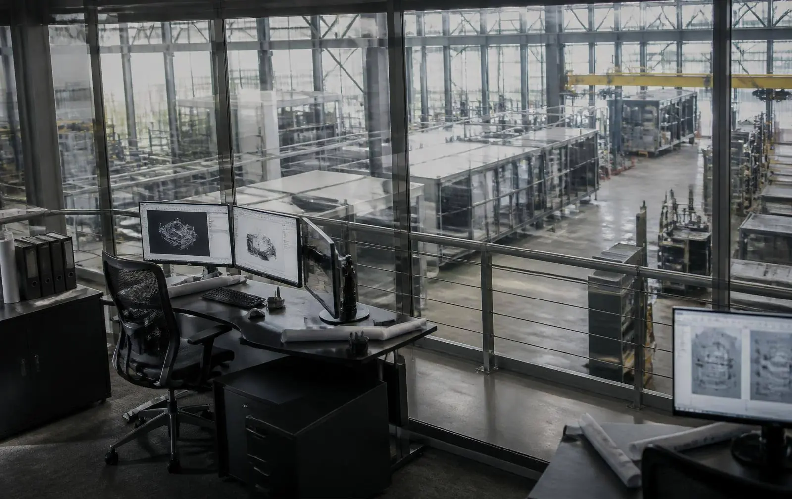 Engineering office overlooking a modern manufacturing facility at dusk
